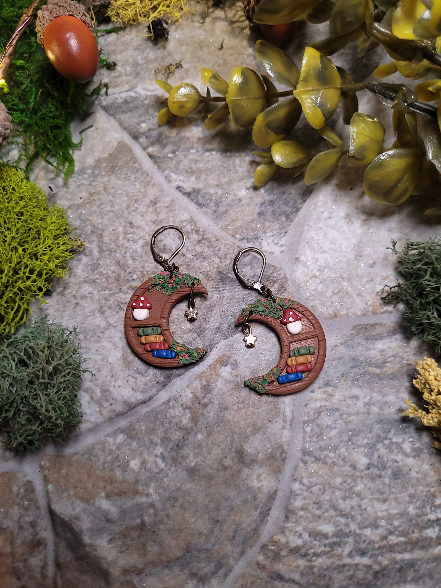 Close up of moon bookshelf on stone background surrounded by foliage.