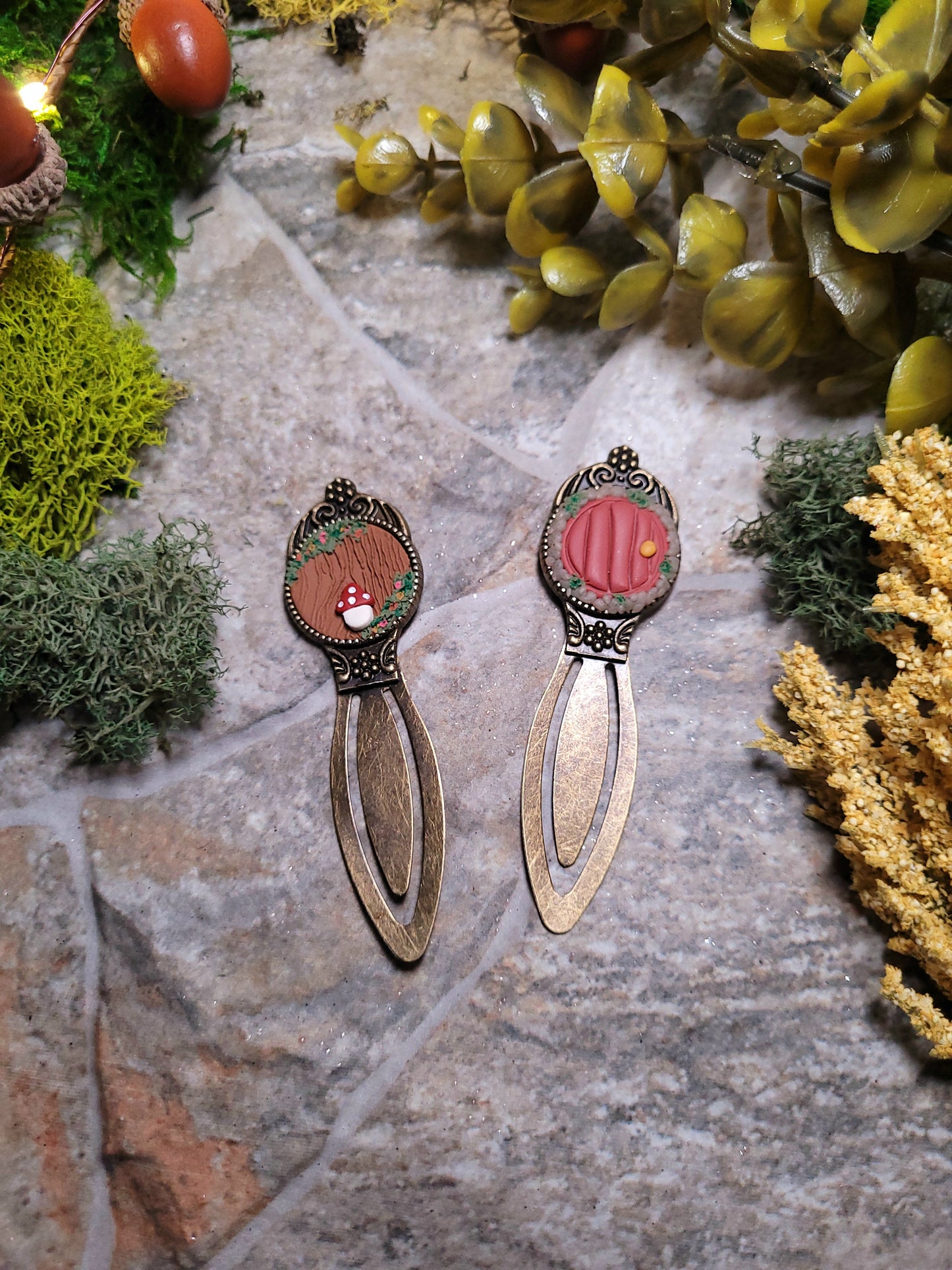 cottage core bookmarks on a stone background surrounded by foliage