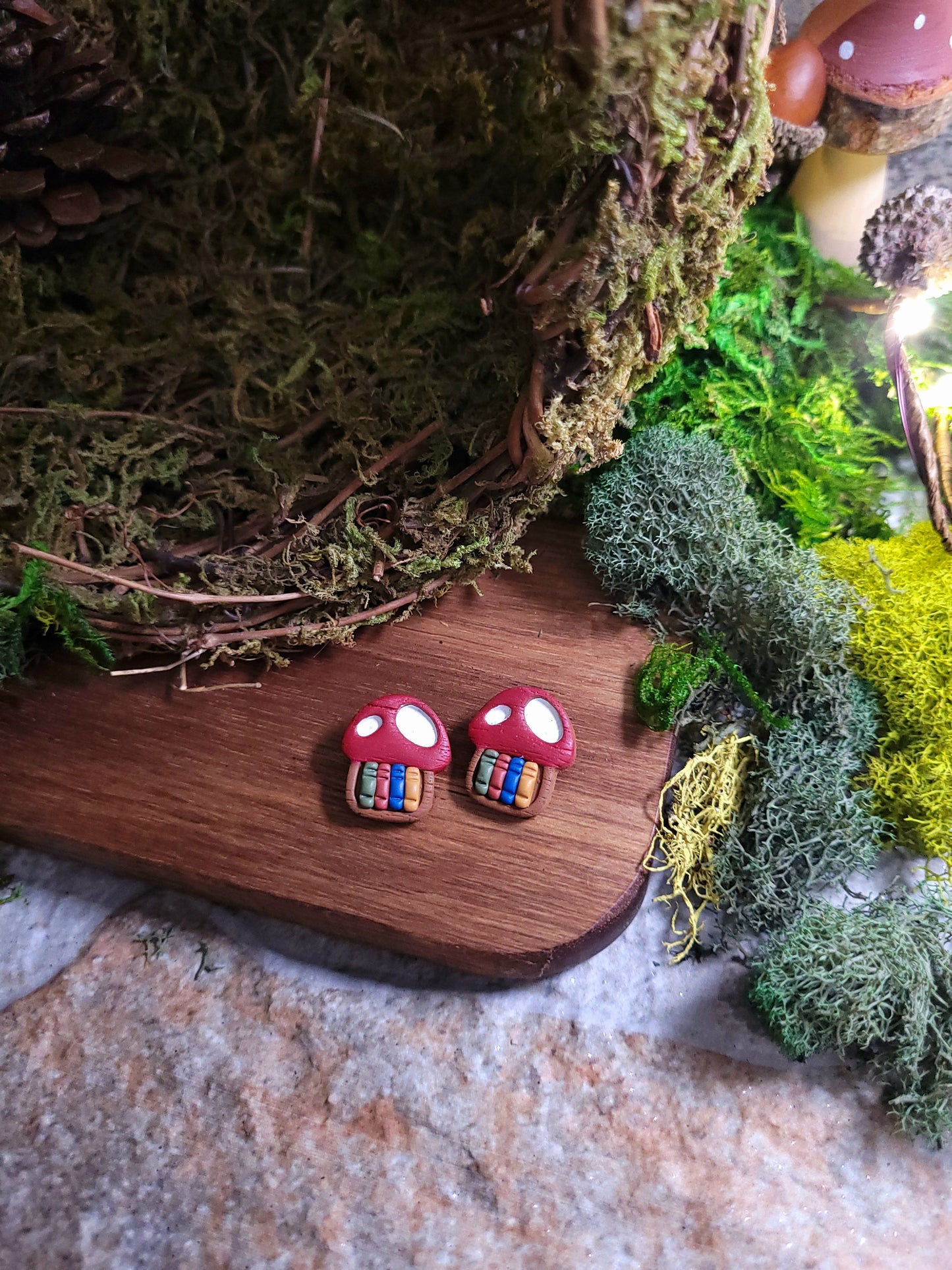 Close up of toadstool studs on wood and stone background surrounded by moss.