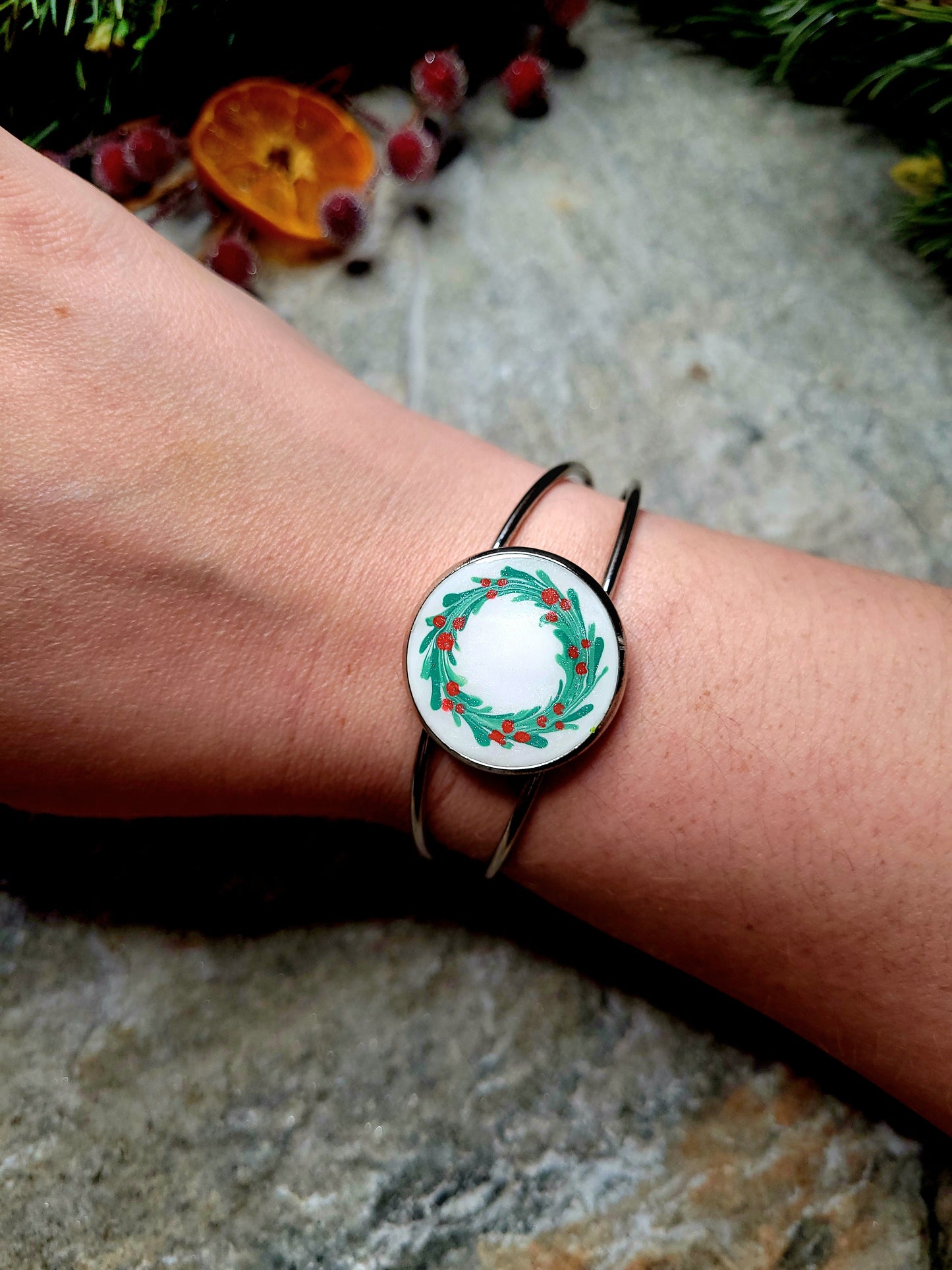silver holly bracelet on a wrist