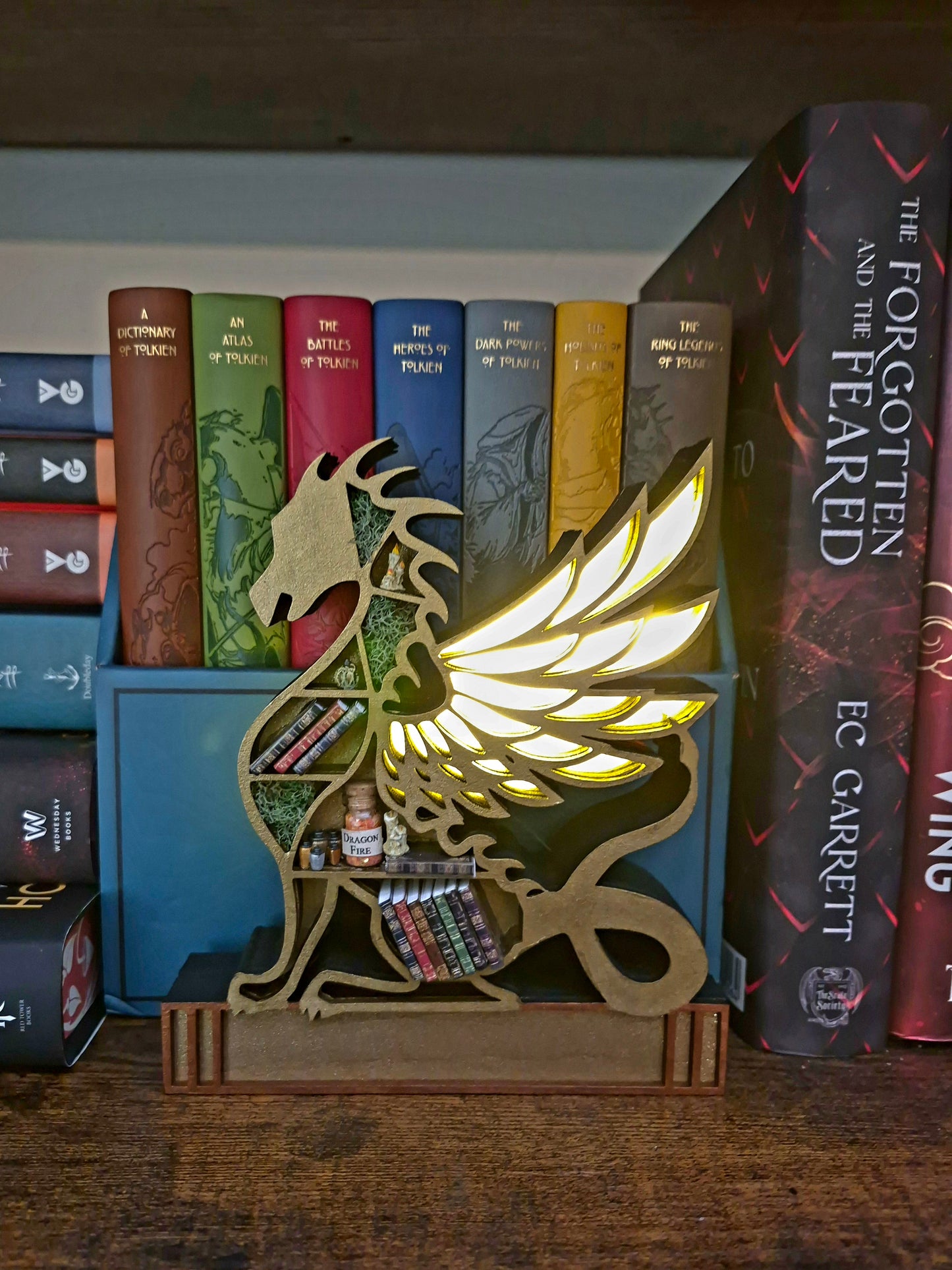 lighted Gold dragon mini bookcase in front of books