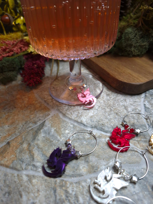 Wine glass with decorative charms on a stone surface