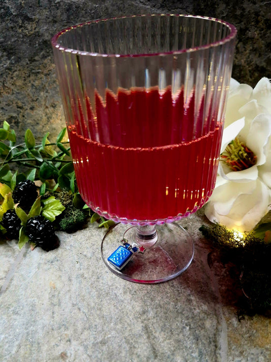 Blue book wine charm on a wine glass
