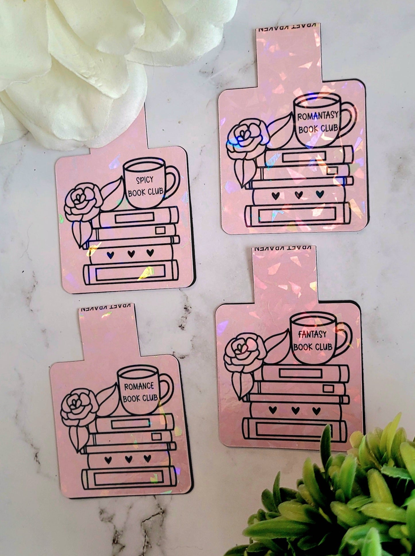 Book Club Book marks on a marble background surrounded by foliage