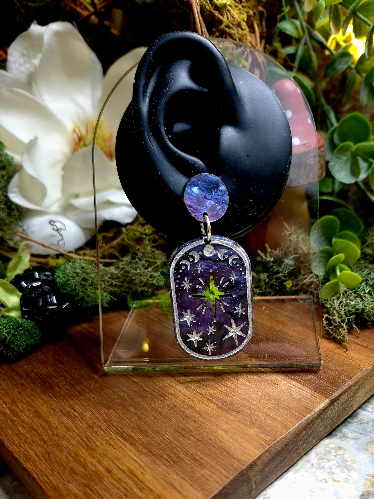 Celestial Galaxy Earrings on a display ear