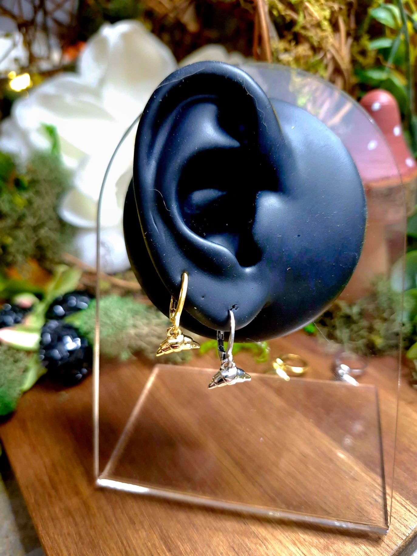 gold and silver croissant charm earrings on display ear