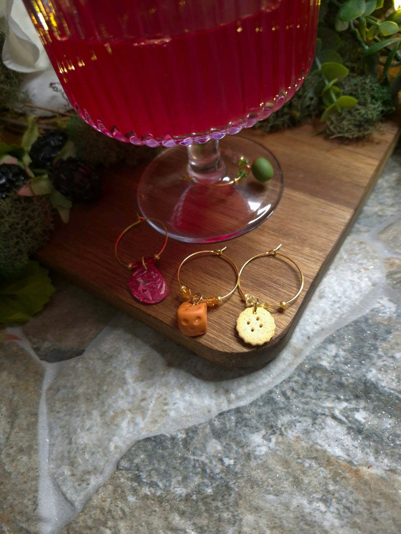 Charcuterie themed wine charms on a wine glass