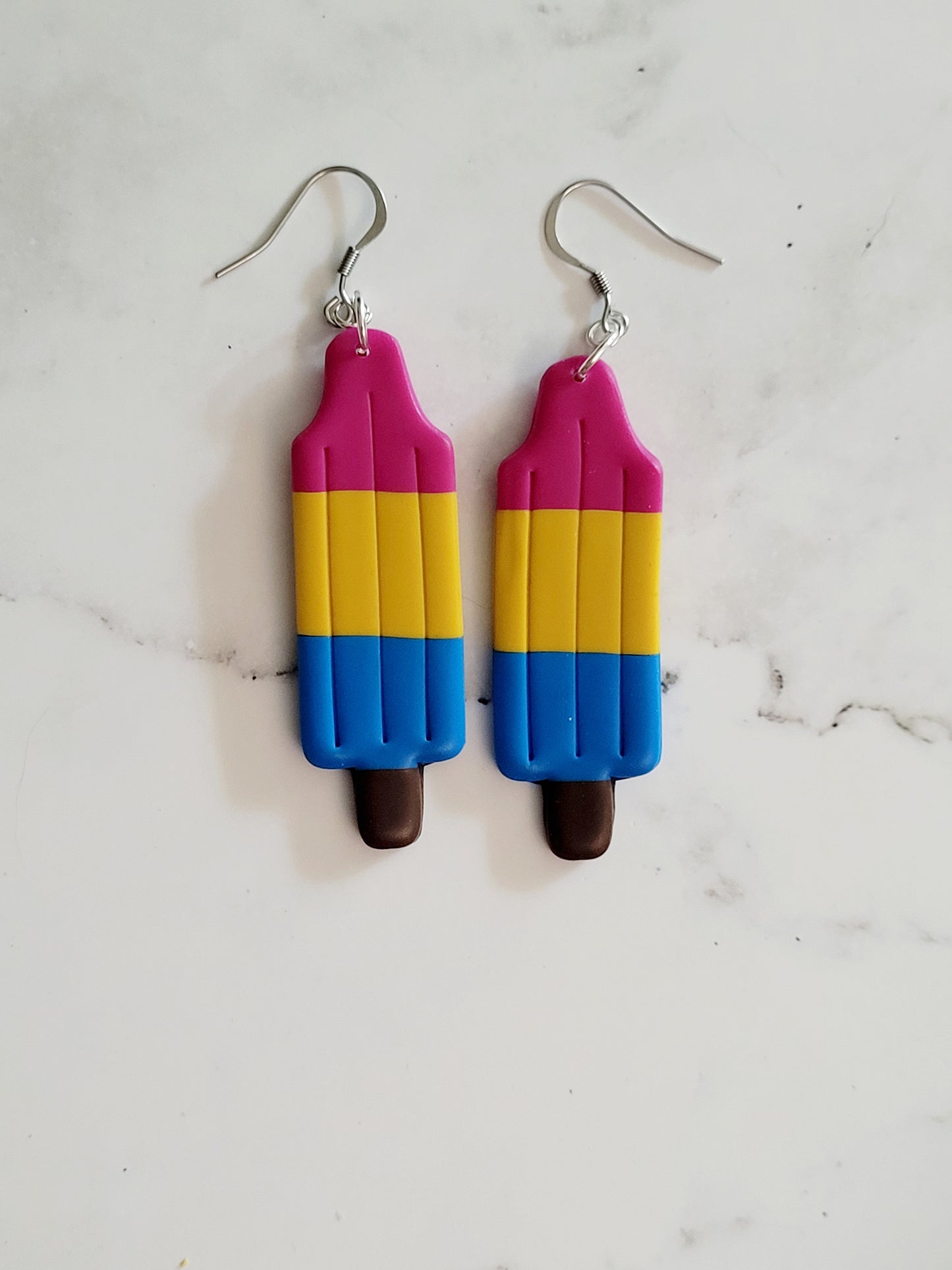 Closeup of the Pan Pride Flag Bomb Pop Earrings