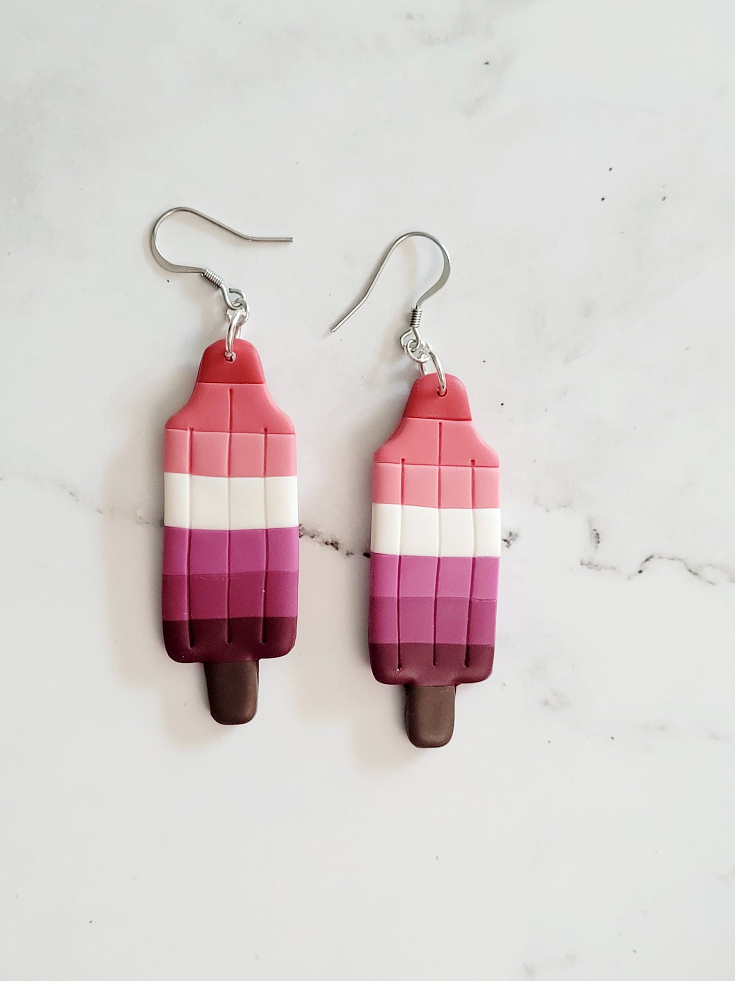 Closeup of the Lesbian Pride Flag Bomb Pop Earrings