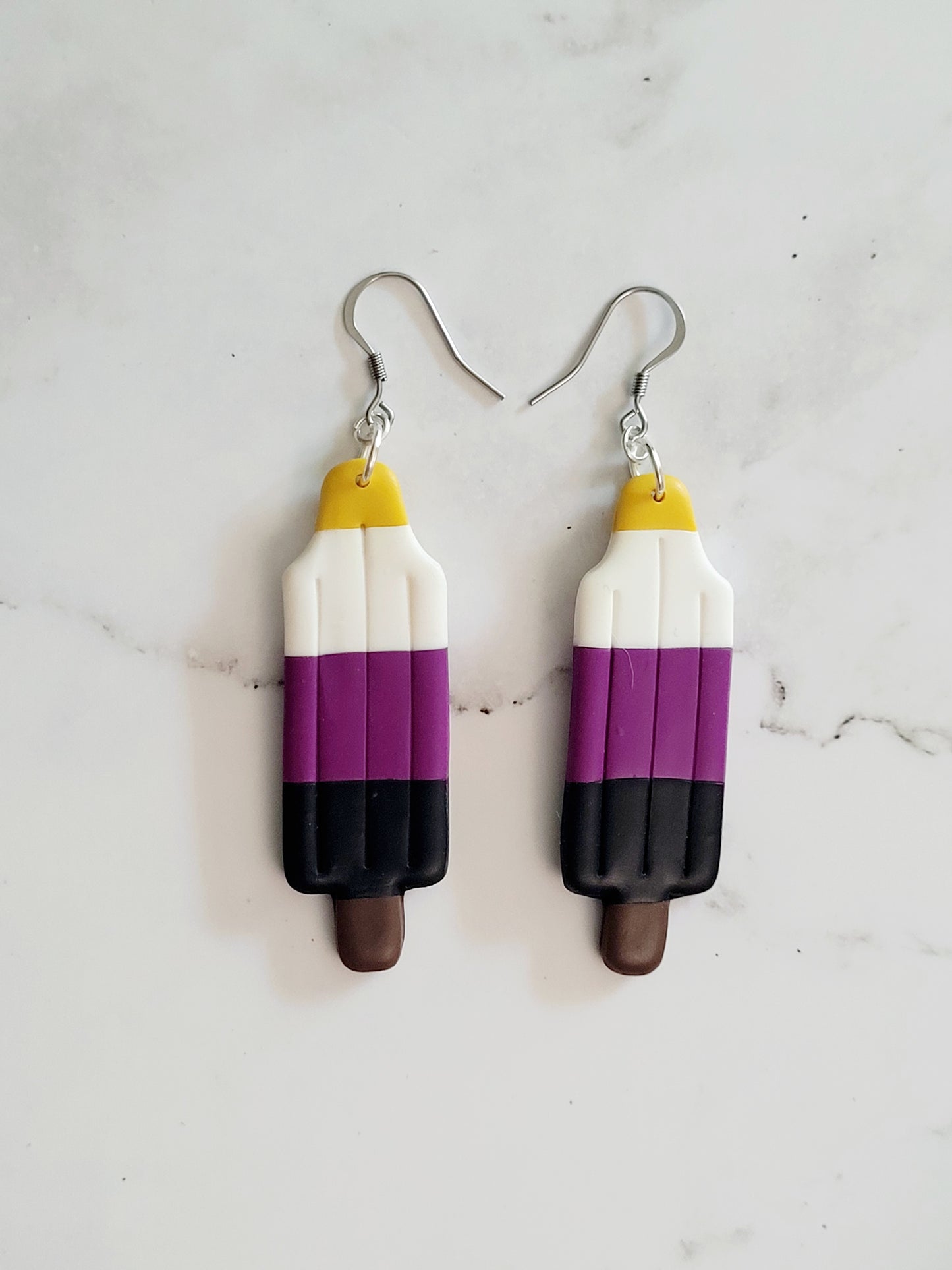 Closeup of the Non Binary Pride Flag Bomb Pop Earrings
