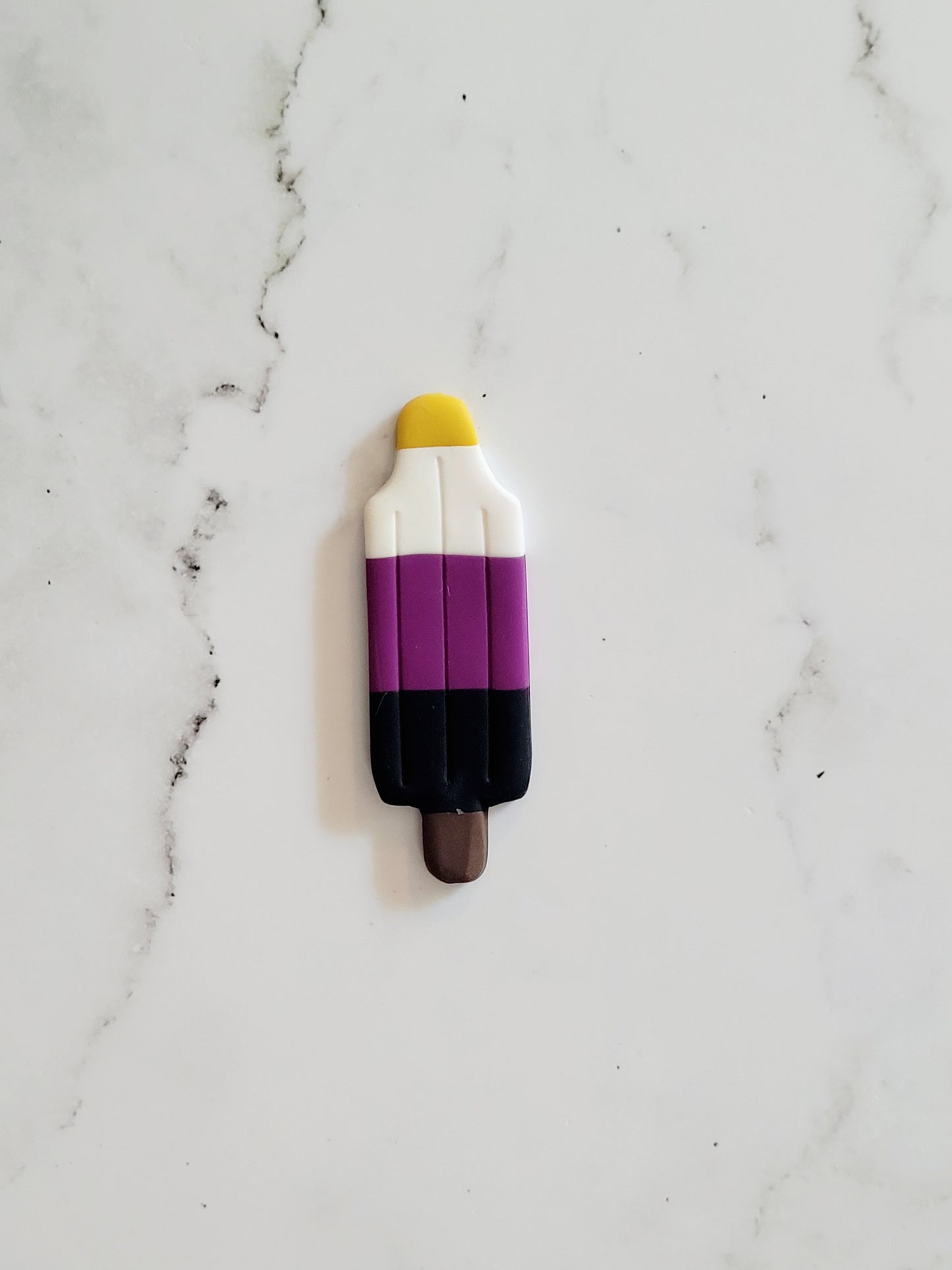 Closeup of the Non-Binary Pride Flag Bomb Pop Pin