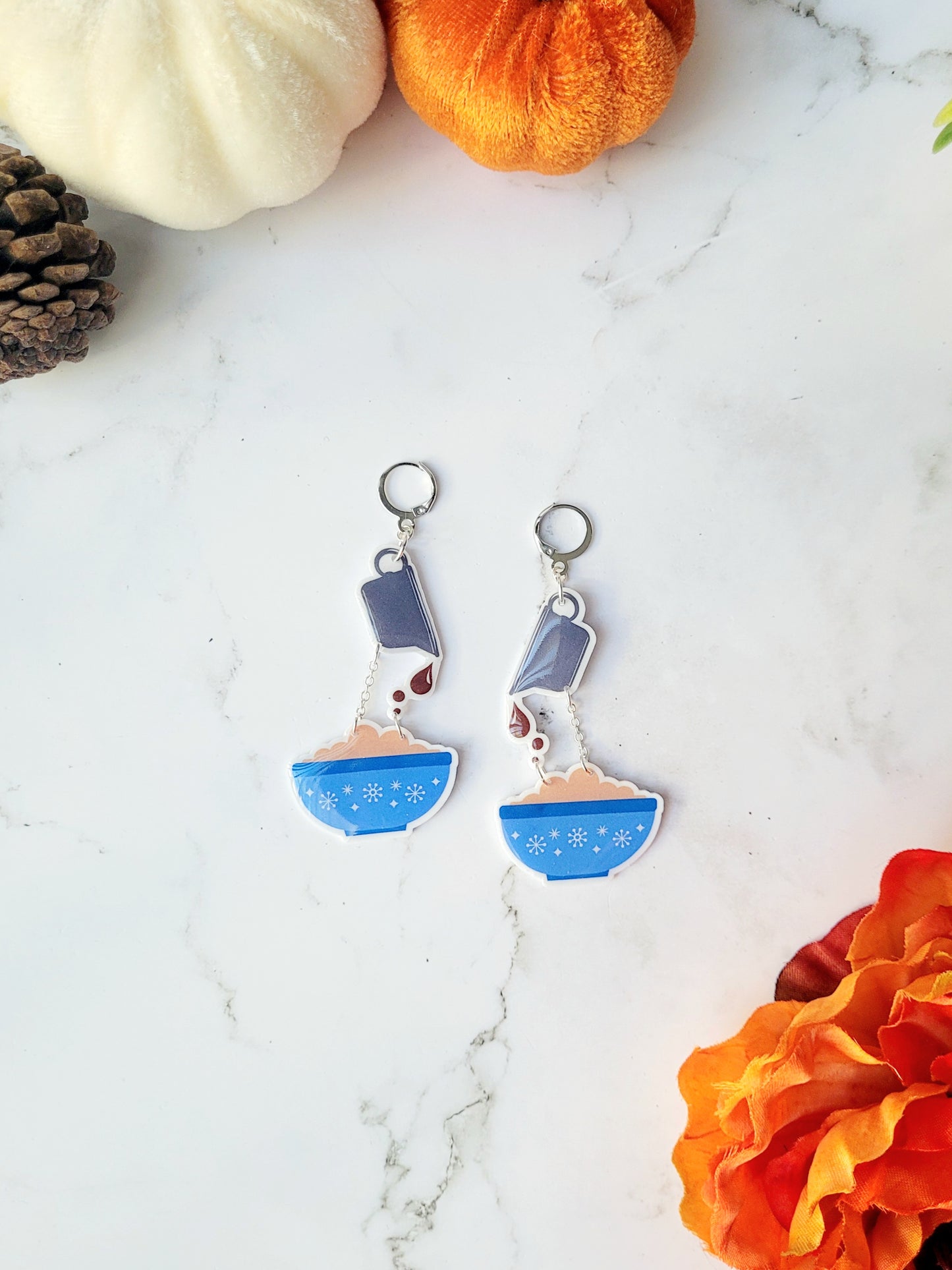 mashed potato and gravy themed earrings on a marble background.