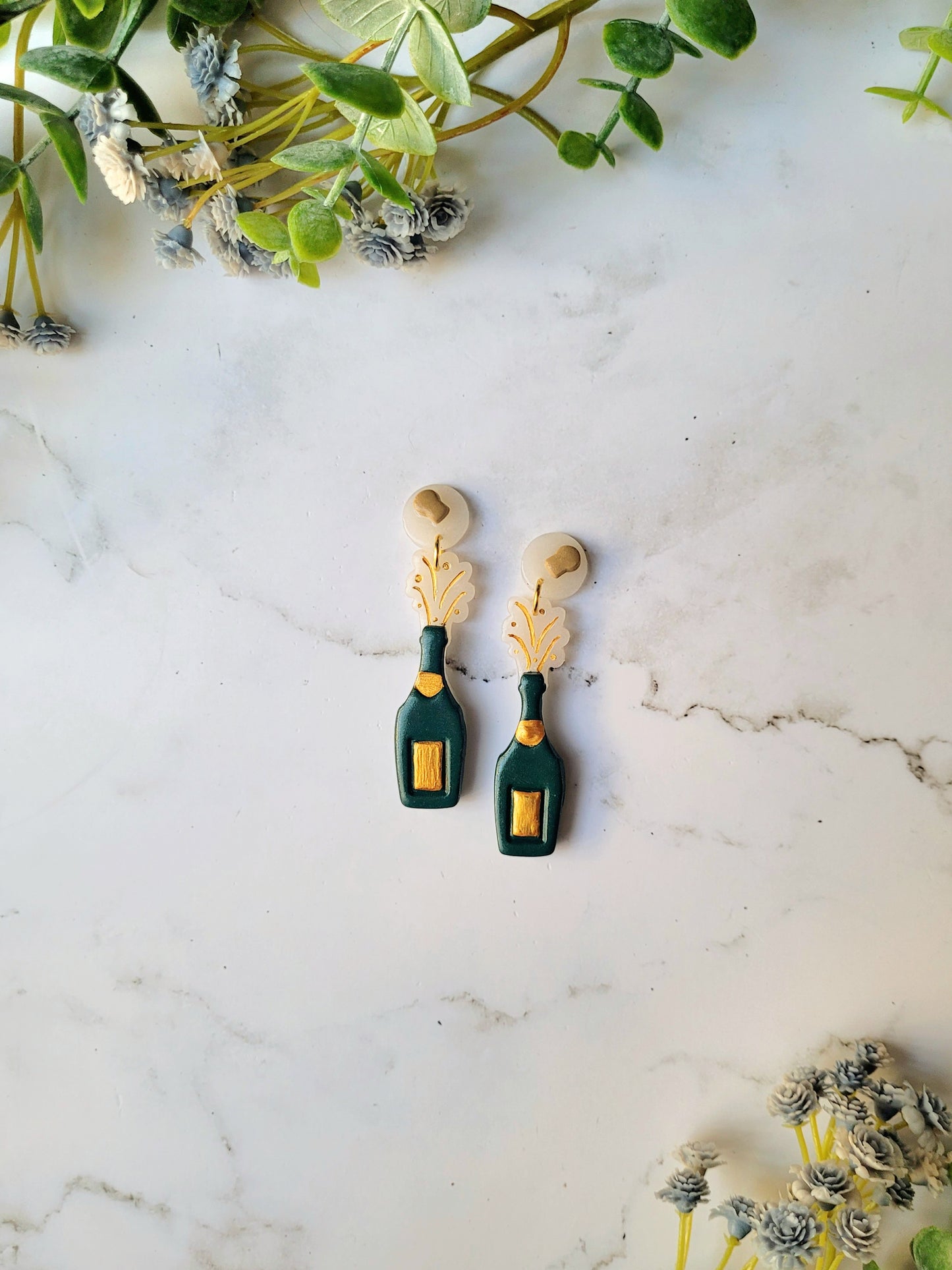 exploding champagne bottle with cork studs on a marble background.