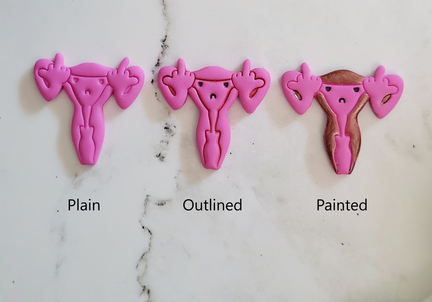 style options of Pink uterus pin with middle finger fallopian tubes.