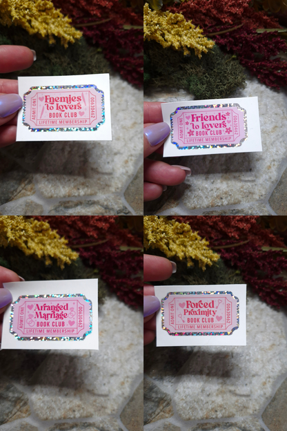 Enemies to Lovers, Friends to Lovers, Arranged Marriage, and Forced Proximity stickers on a stone background. 