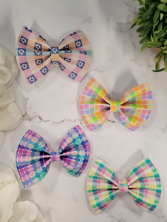 4 plaid bows on a marble background. 