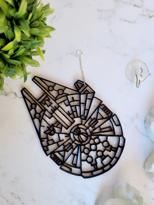 Star Wars sun catcher on marble background surrounded by foliage