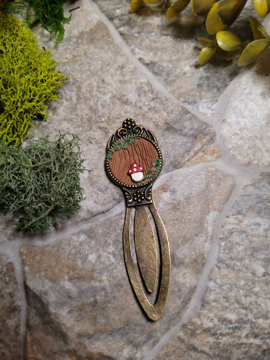 mossy tree bookmark on a stone background surrounded by foliage