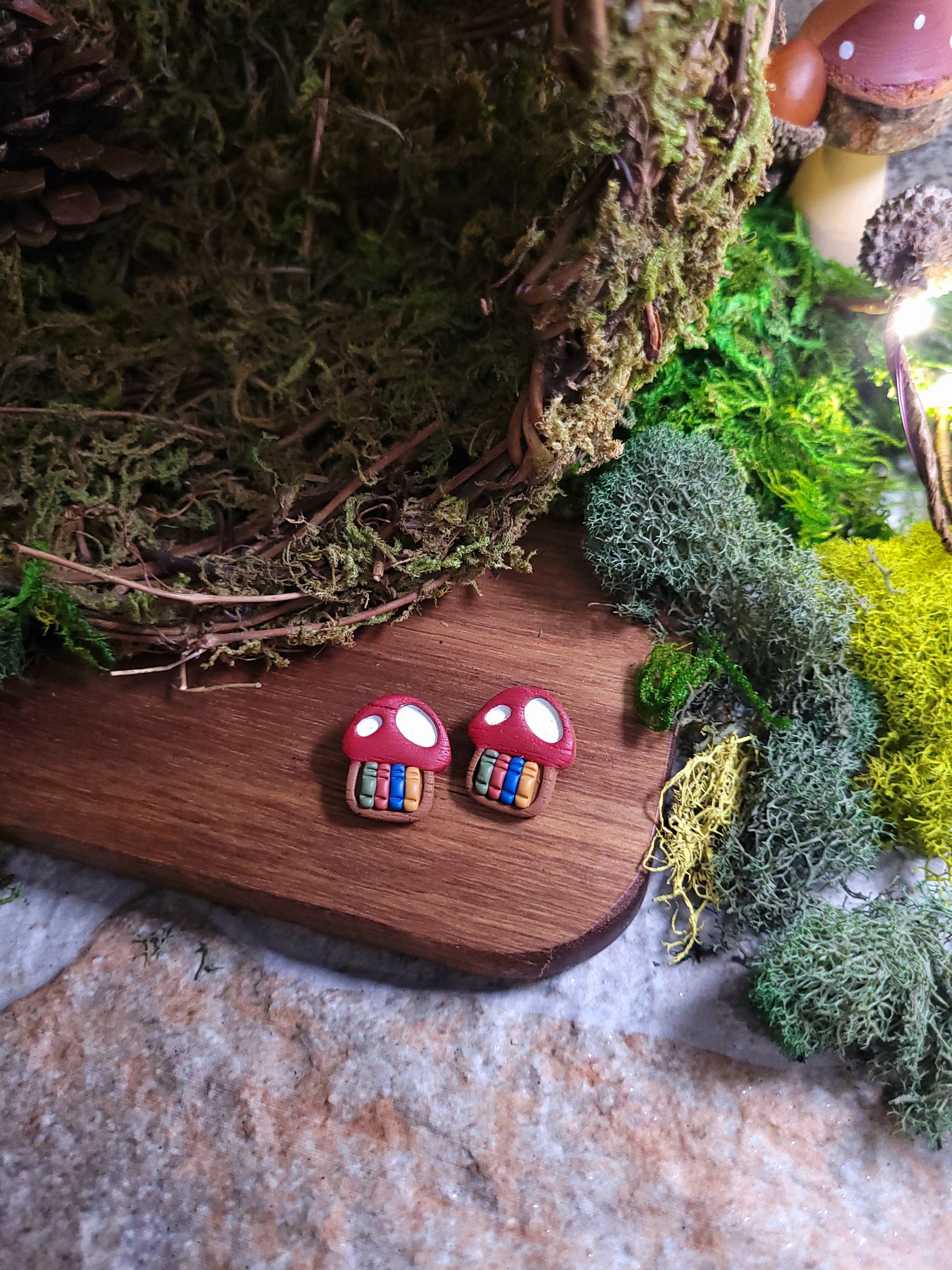 Close up of toadstool studs on wood and stone background surrounded by moss. 