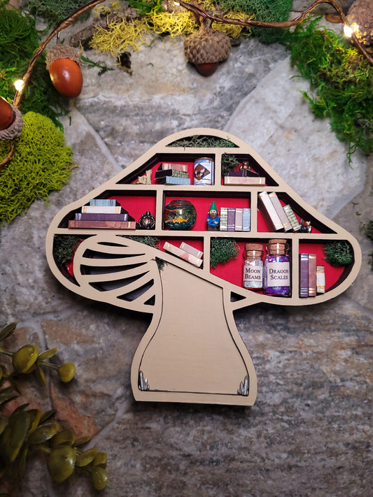 Unlit Mushroom Mini Bookshelf on a stone background surrounded by foliage. 