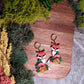 Floral fox earrings on a wood and stone background surrounded by foliage. 