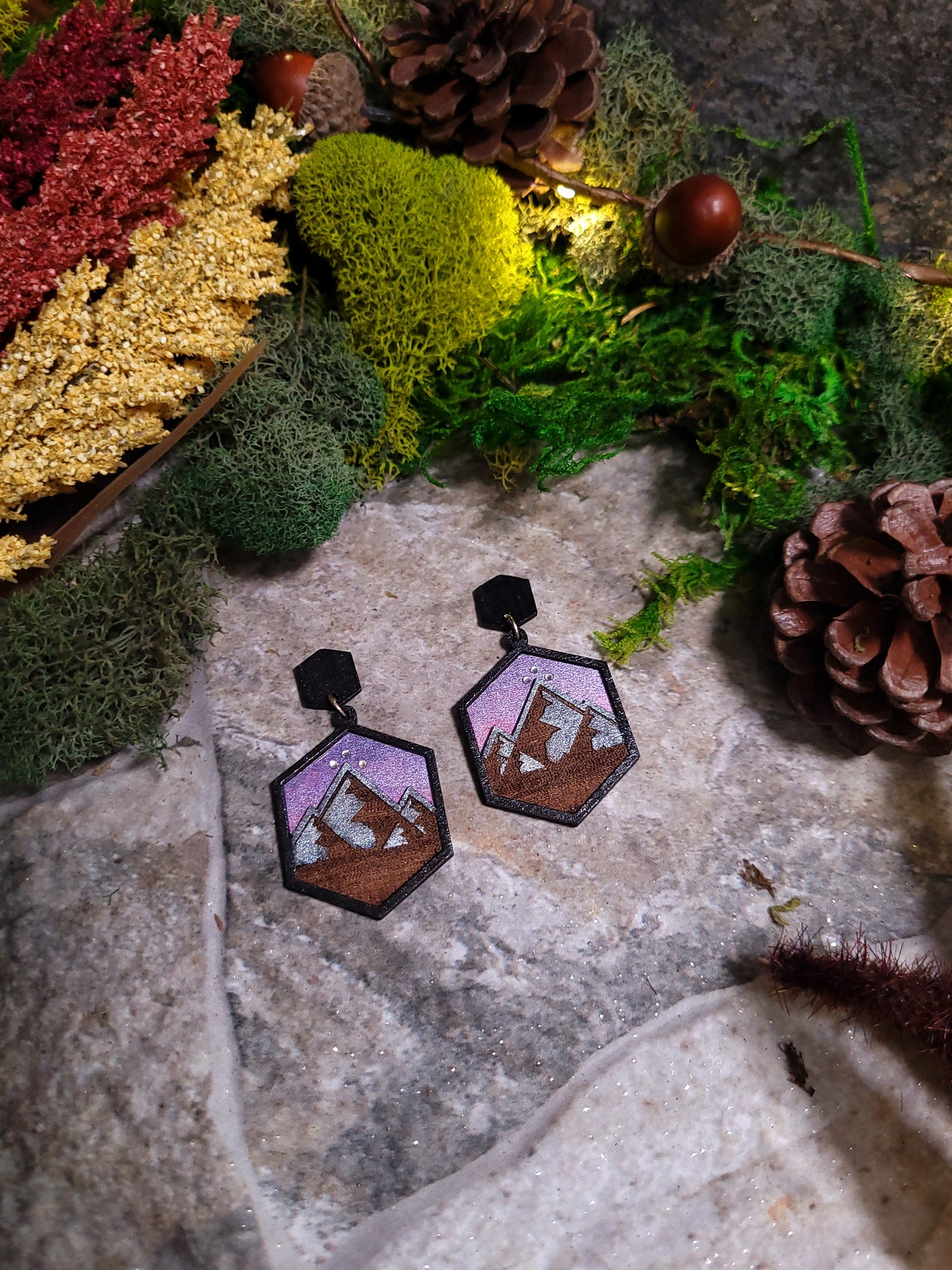 Night Court Earring on a stone background surrounded by foliage