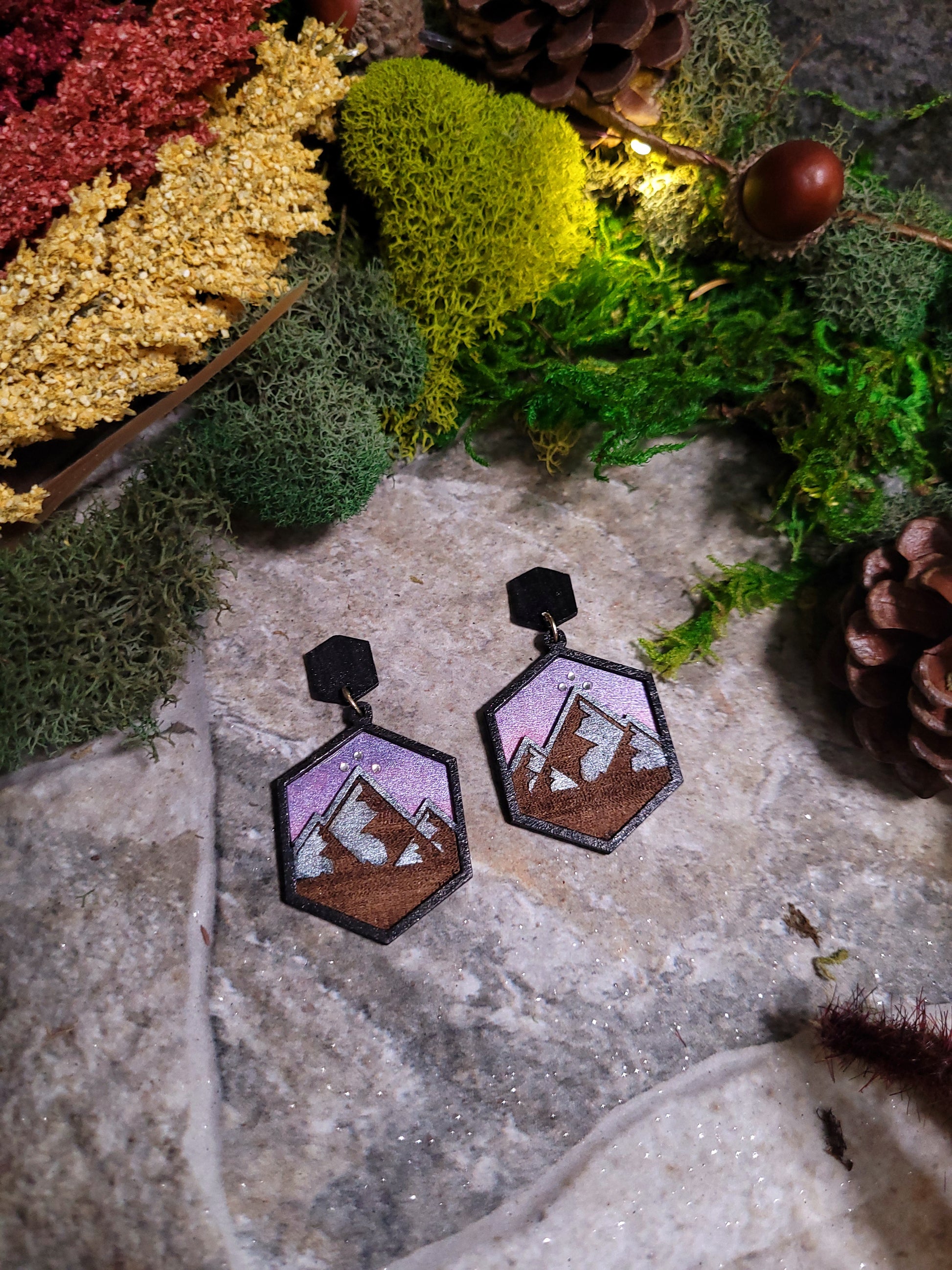 close up of Night Court Earring on a stone background surrounded by foliage