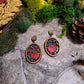 Spring Court Earrings on a stone background surrounded by foliage