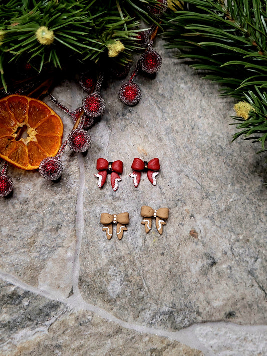 Christmas Bow studs on a stone background surrounded by foliage