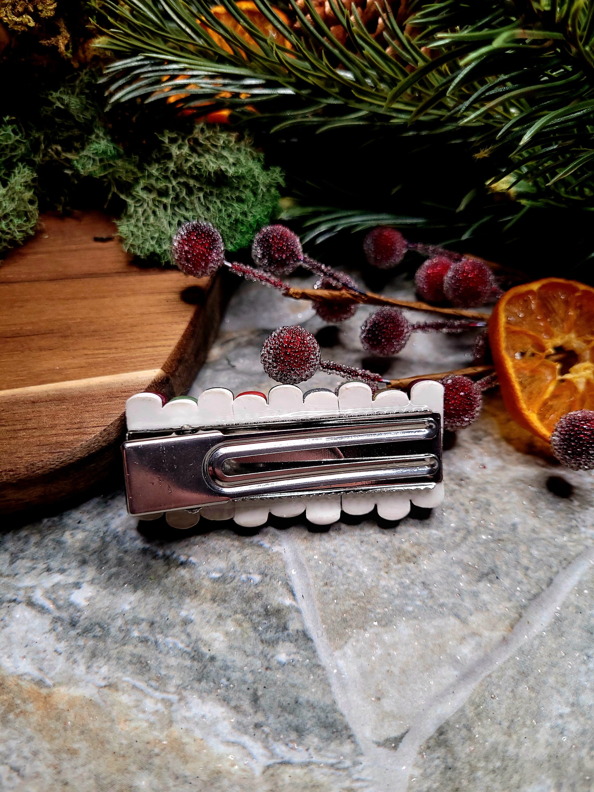 Back of bookstack clip on a wood and stone background surrounded by moss and foliage