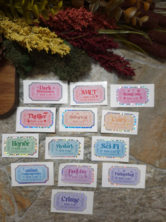 Book Genre Stickers on a stone background surrounded by foliage. 