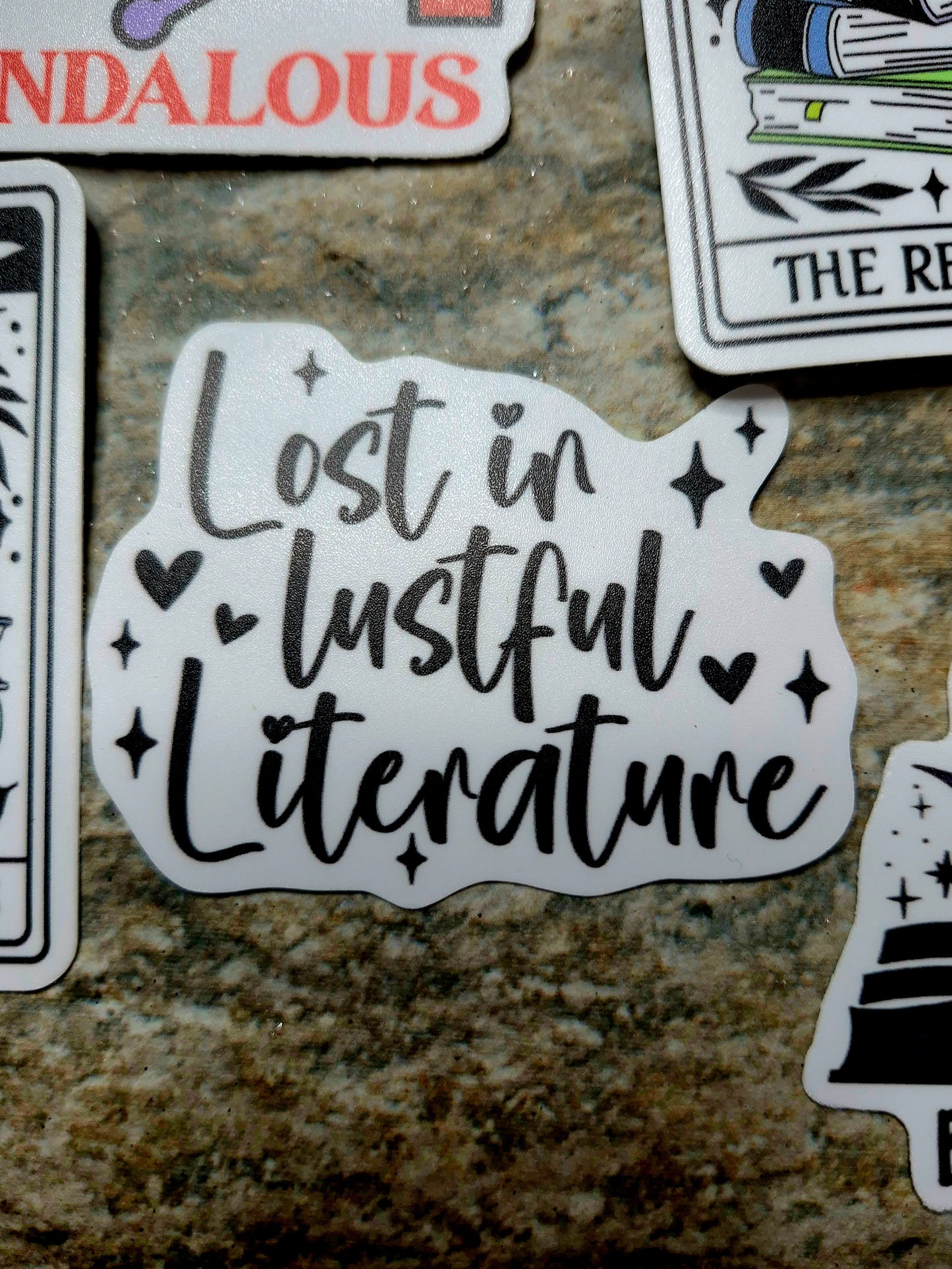 Lost in lustful literature sticker on stone background 