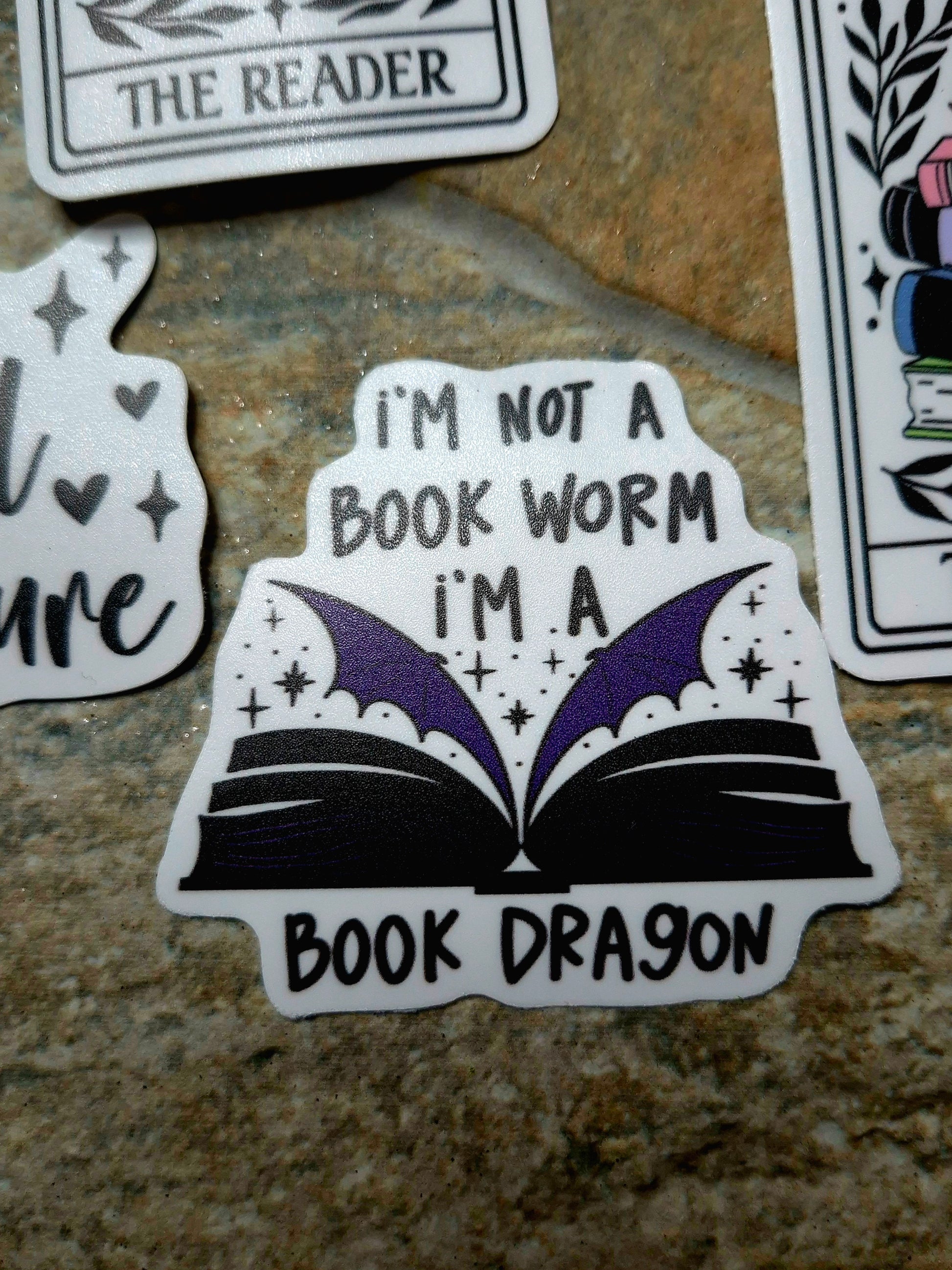 Book Dragon sticker on a stone background 
