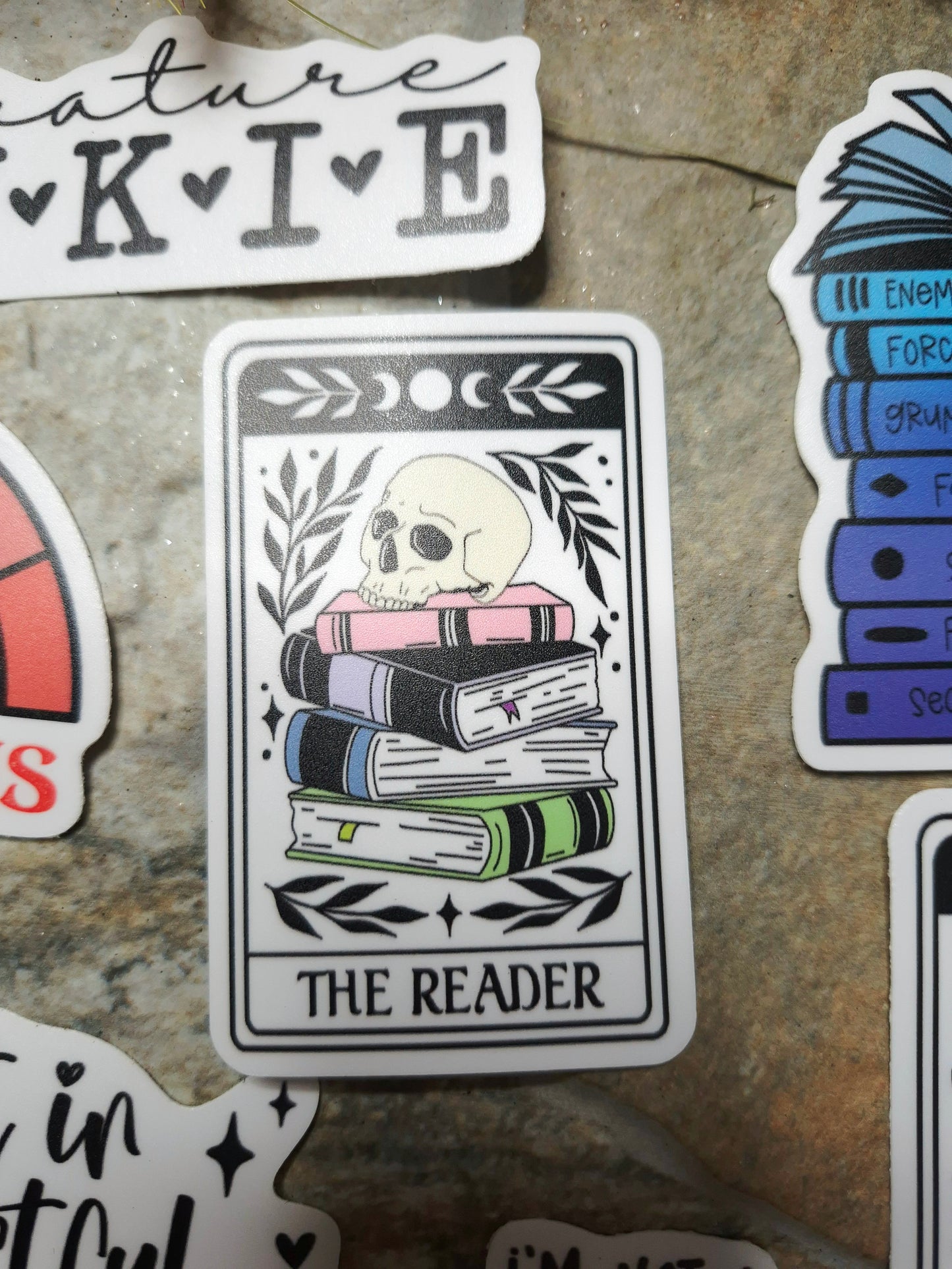 the reader tarot sticker on stone background 
