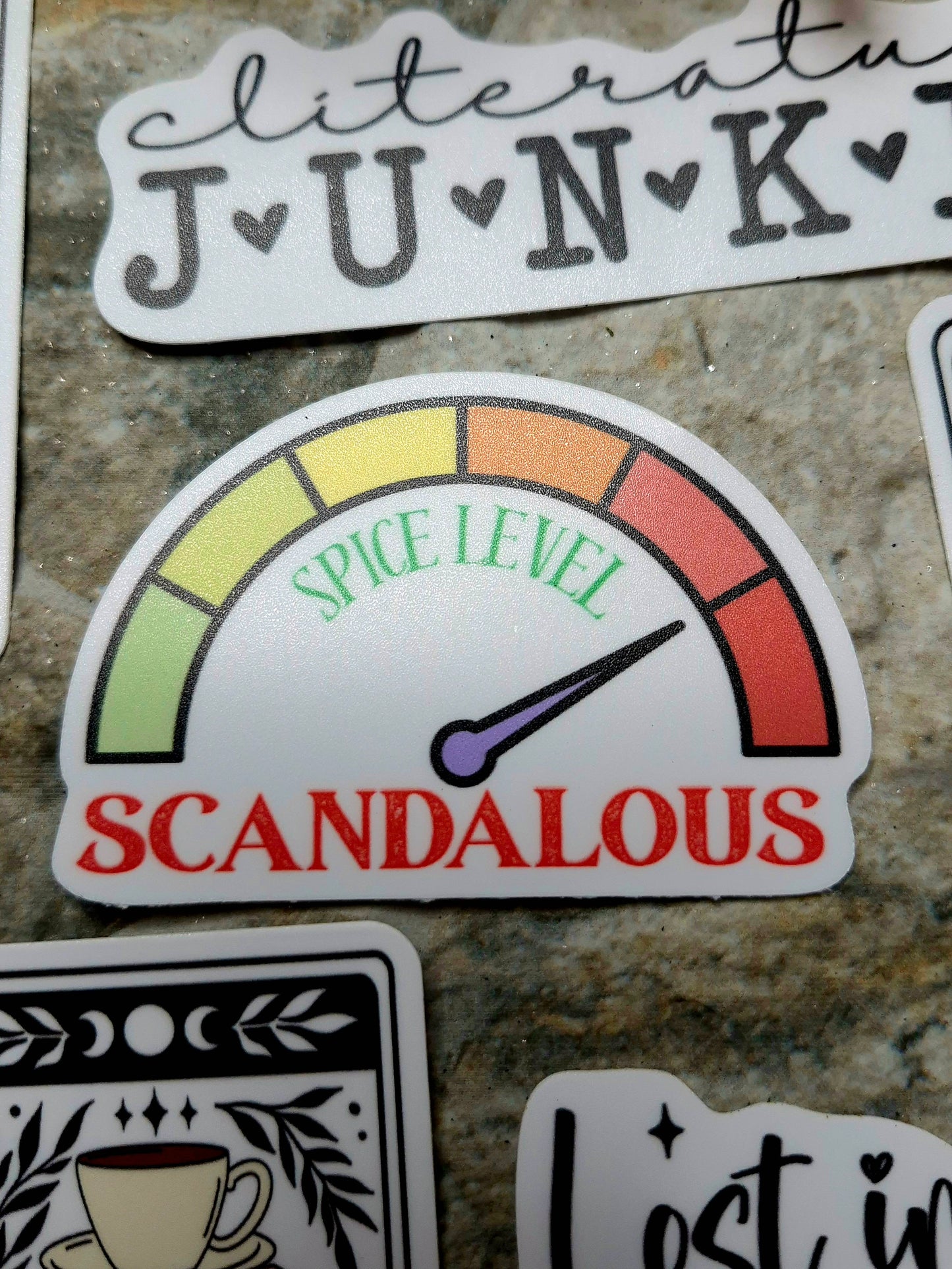 spice level scandalous sticker on a stone background 