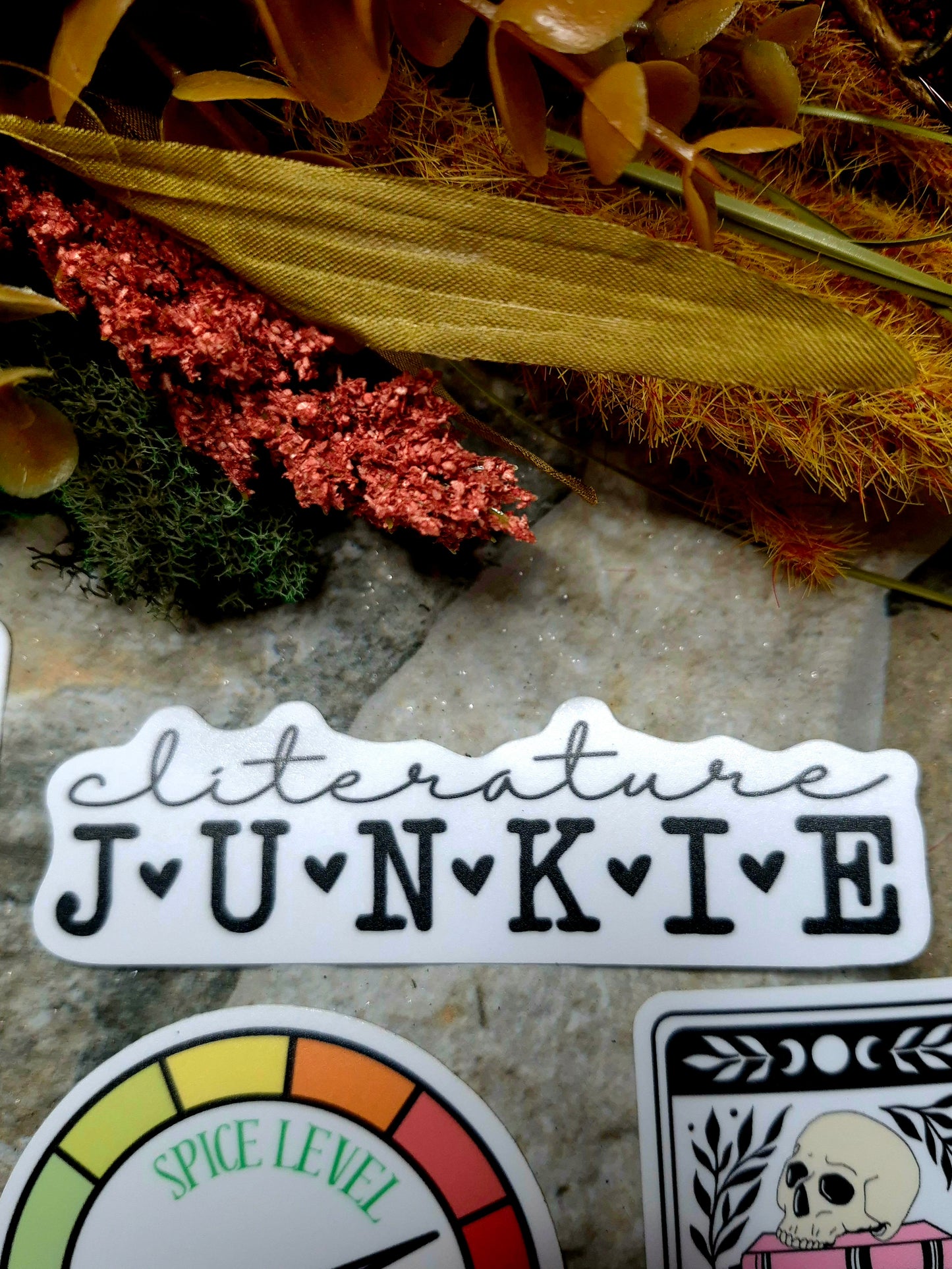 cliterature junkie sticker on a stone background 