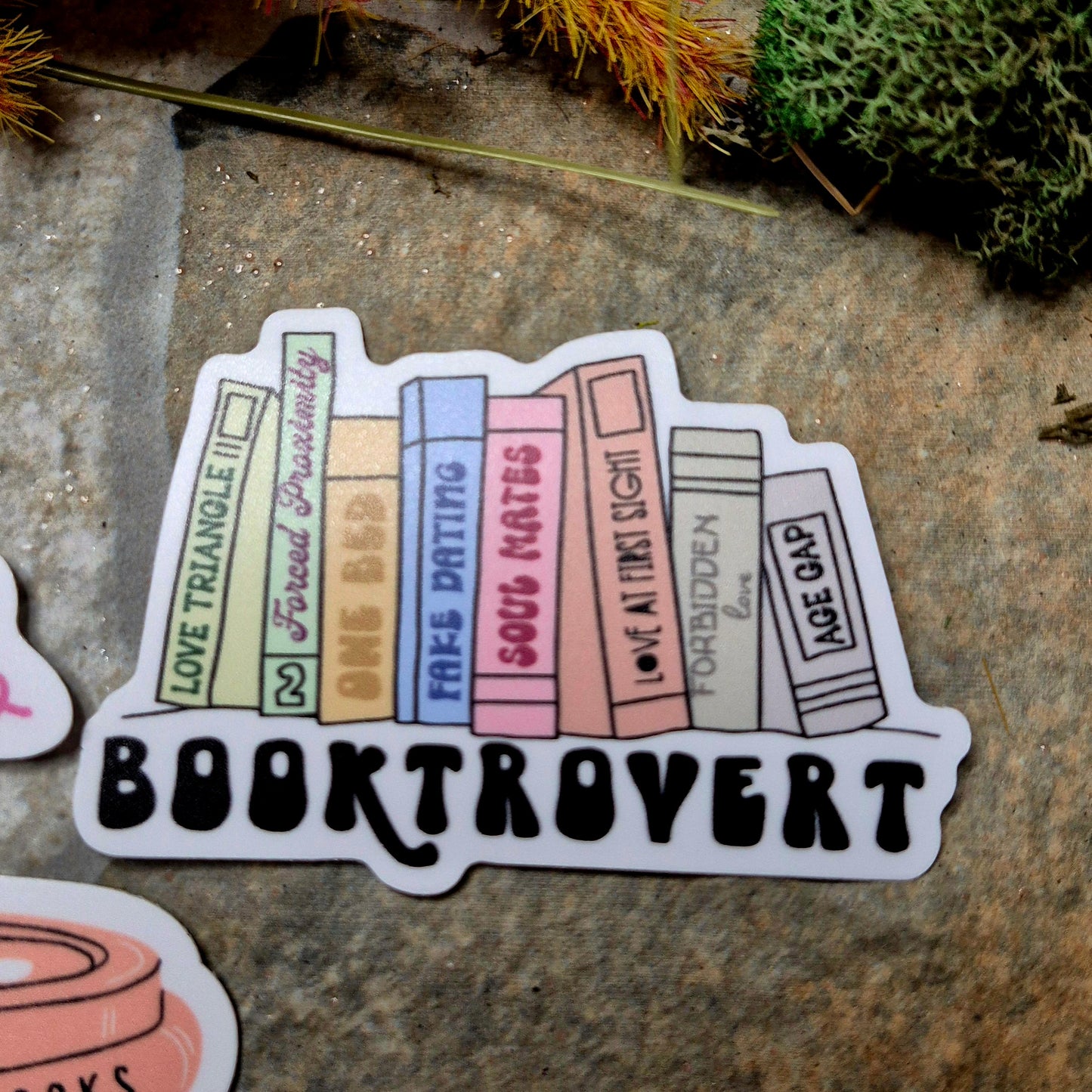 booktrovert sticker on a stone background 