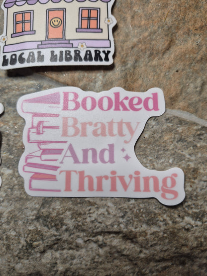 Booked Bratty Thriving Sticker on stone background 