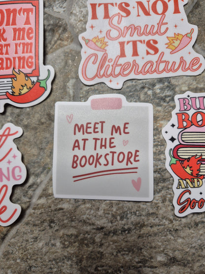 meet me at the bookstore sticker on a stone background 