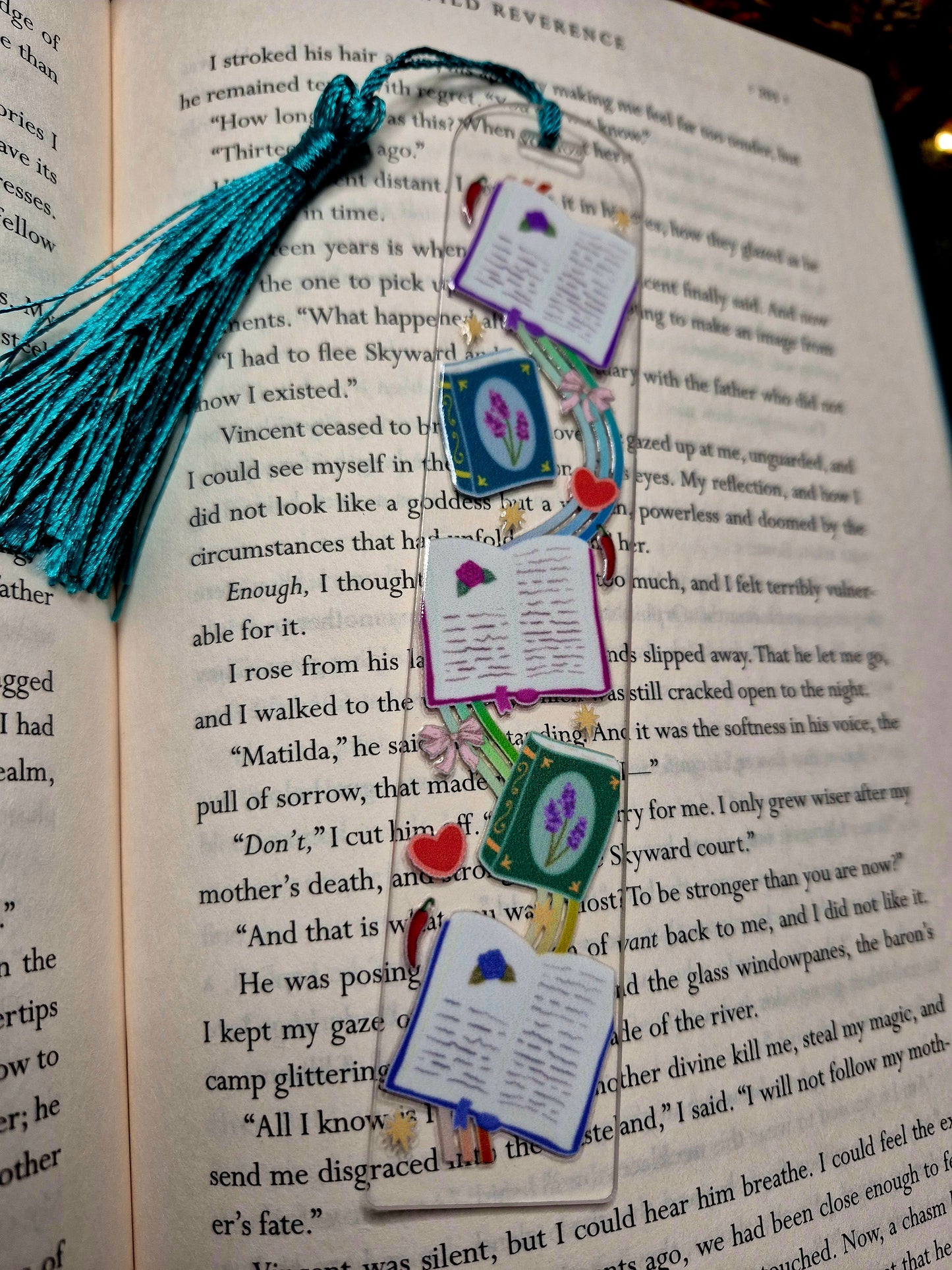 Romantasy bookmark on a book background. 