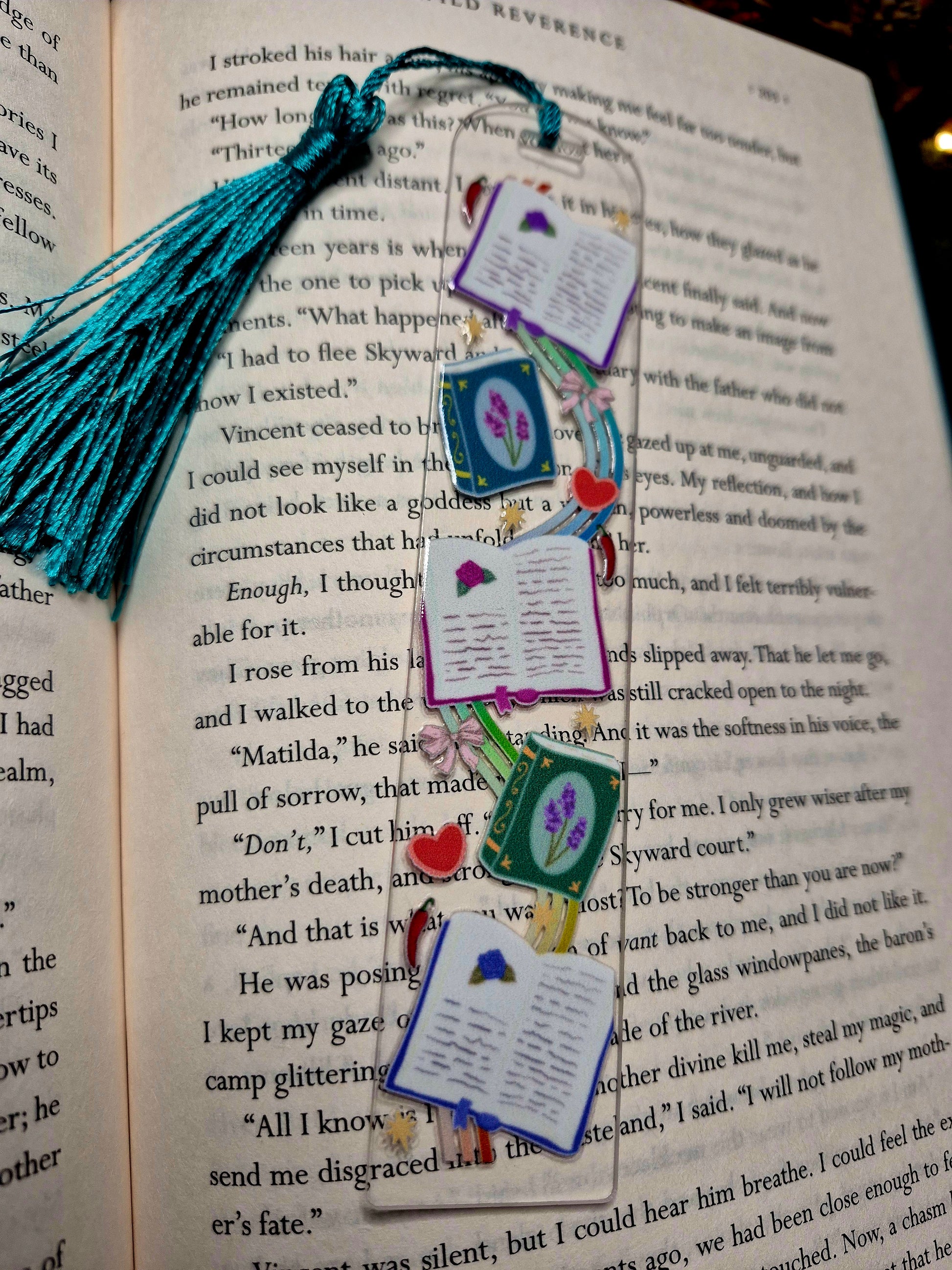 Romantasy bookmark on a book background. 