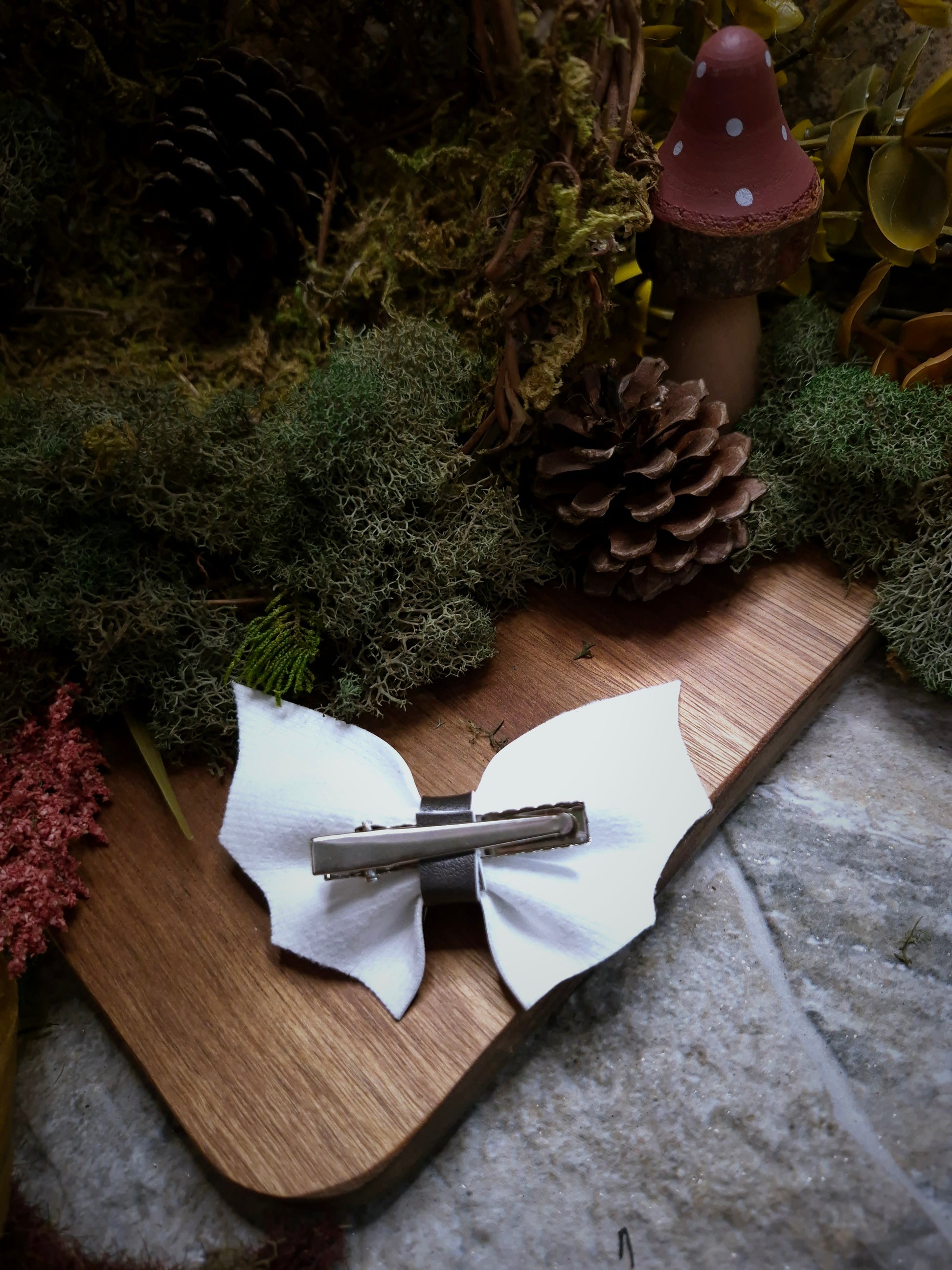 back of Halloween stripe bat bow on a wood and stone background 