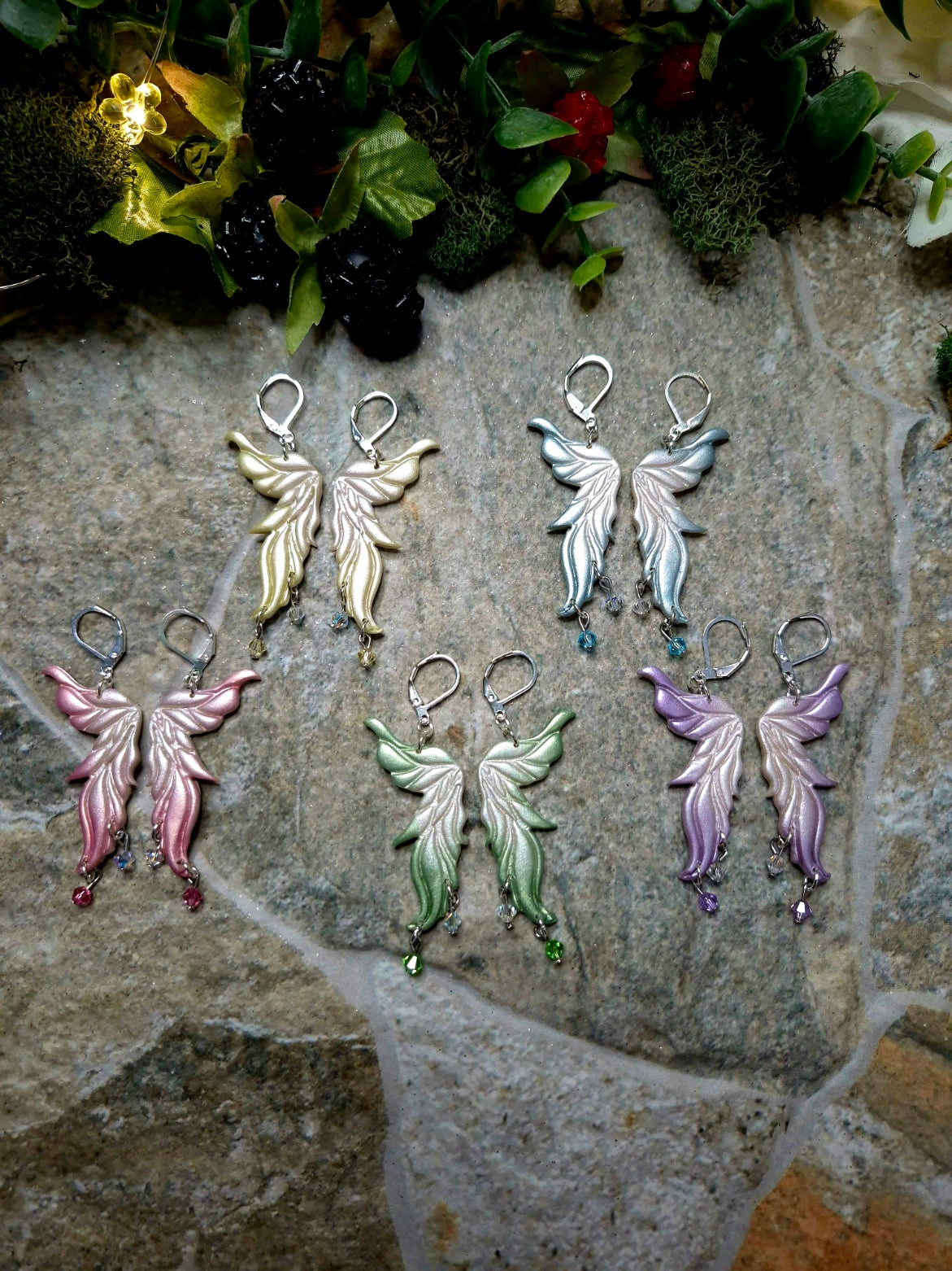 Fairy Wing Earrings on a stone background 
