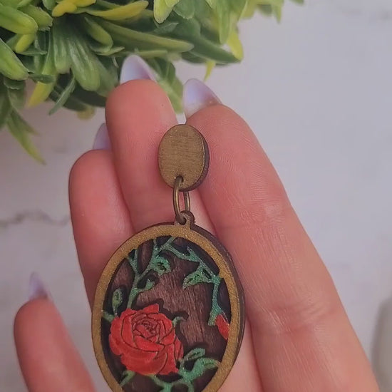 video close up of Spring Court Earrings on a marble background surrounded by foliage