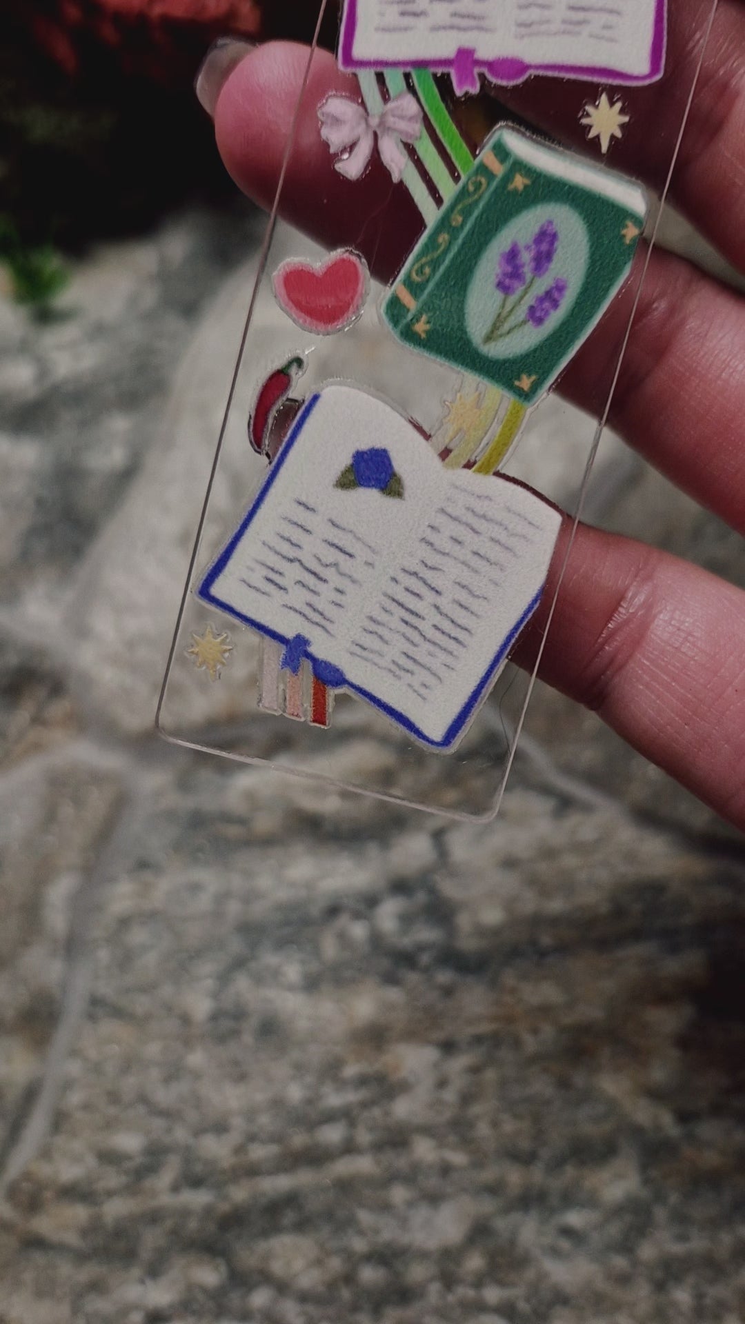 video of romantasy bookmark on a stone background