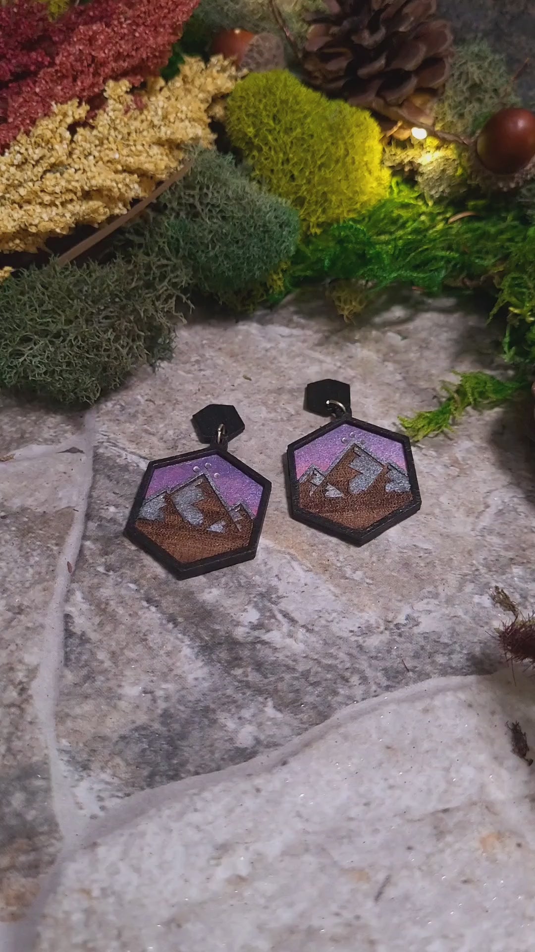 video close up Night Court Earring on a stone background surrounded by foliage