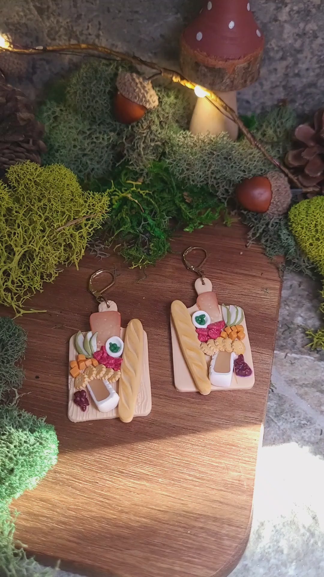 video close up of charcuterie board earrings on a wood background. 