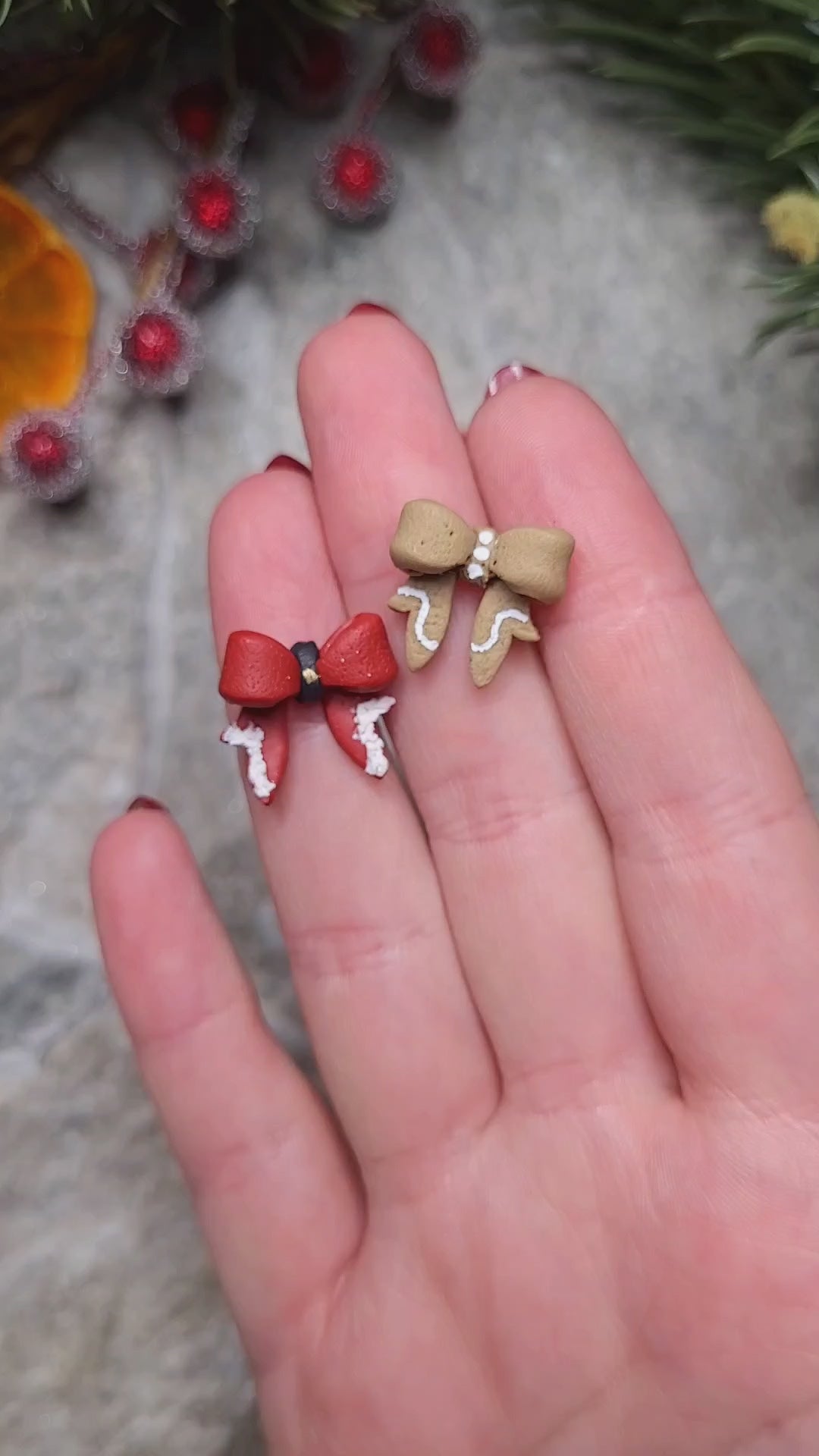 Video close up on Christmas Bow studs on a stone background surrounded by foliage