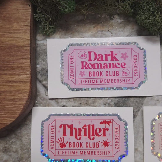 video of Book Genre Stickers on a stone background surrounded by foliage. 
