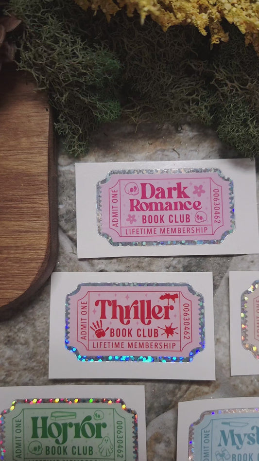video of Book Genre Stickers on a stone background surrounded by foliage. 